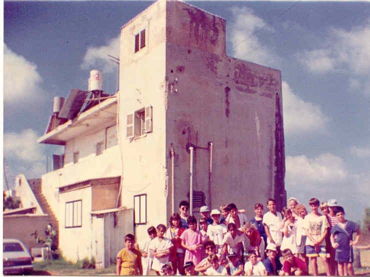 ילדי יד מרדכי מצטלמים ליד המבנה המרכזי של "מצפה הים" במהלך ביקור שורשים, שנות השמונים.